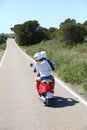 Back view of couple riding moto heading to the sea