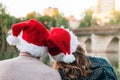 Back view of a couple in Santa hats on Christmas 2021.Concept of reunion and return home Royalty Free Stock Photo