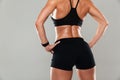 Back view cropped image of a healthy muscular woman