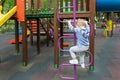 Back view cute adorable caucasian blond little toddler boy kid having fun enjoy climbing metal stairs at children modern Royalty Free Stock Photo