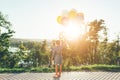 Cute girl holding colorful balloons in the city park dreaming Royalty Free Stock Photo