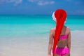 Back view of cute girl in red hat santa claus on Royalty Free Stock Photo