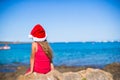 Back view of cute little girl in Santa hat on the Royalty Free Stock Photo