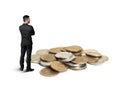 Back view cutout businessman standing in front of a copper heap ruble coins Royalty Free Stock Photo