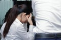 Back view of depressed stressed young Asian business woman suffering from severe problem in office. Royalty Free Stock Photo