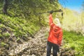 Back view determined hiker solo woman lift up nordic stick out of joy on hike up