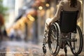 Back view on disabled woman walks on a wheelchair, enjoys warm autumn weather.