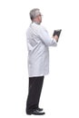 Back view of a doctor writing something on a blank paper of a clipboard Royalty Free Stock Photo