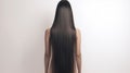 Back View of Elegant Woman with Long, Shiny Black Hair on a White Background. Showcasing the health and shine of her Royalty Free Stock Photo