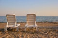 Back view empty chaise lounge before ocean. Royalty Free Stock Photo