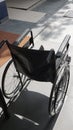 Back view empty wheelchair on the front of hospital entrance with day natural light and shadow Royalty Free Stock Photo