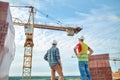 Experienced construction workers in hardhats checking the building site Royalty Free Stock Photo