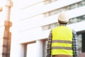 Back view of engineering man construction worker wear safety helmet and wear reflective clothing for the safety of the work operat Royalty Free Stock Photo