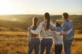 Back view of family of four looking into the distance enjoying sunset and beautiful nature. Royalty Free Stock Photo