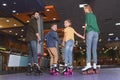 back view of family holding hands while skating on roller