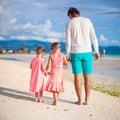 Back view of father and two girls walking on Royalty Free Stock Photo