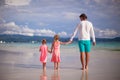 Back view of father and two girls walking on Royalty Free Stock Photo