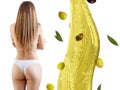 Back view on female body near olive oil splash. Royalty Free Stock Photo