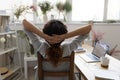 Back view of female designer resting on chair in studio Royalty Free Stock Photo