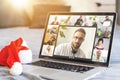 Back view of female employee engaged in team Webcam conference on laptop, have online briefing or consultation from home Royalty Free Stock Photo