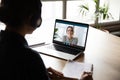 Back view of female employee have web conference with coworker Royalty Free Stock Photo