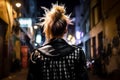 Back view of female punk in leather jacket.