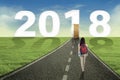 Female student walking toward entrance door Royalty Free Stock Photo