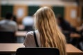 Back view of female student sitting at the desk and listening to lecture in lecture hall, A high school girl with flowing open Royalty Free Stock Photo