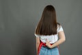 Back view of female supermarket employee making obscene gesture Royalty Free Stock Photo