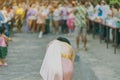 Back view of female in Thai dress take a photo of a Thai dance parade in Songkran festival