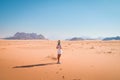 Back view female tourist stand curious watch wadi rum desert landscape panorama of Jordan countryside Royalty Free Stock Photo