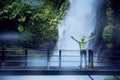 Female tourist enjoys Situ Gunung waterfall view Royalty Free Stock Photo