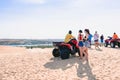 Back view of female tourists enjoy riding the quad bike or powerful fast off-road four-wheel drive ATVs at white sand dunes in Mui