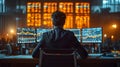 Back view of a financial analyst day trader working on computer with many screens that shows real-time stock data. Royalty Free Stock Photo