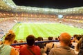 Back view football fans at stadium bleechers during match Royalty Free Stock Photo