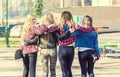 Back view of four girl friends hugging Royalty Free Stock Photo