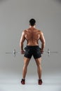 Back view full length of a muscular shirtless male bodybuilder Royalty Free Stock Photo