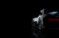 Back view of a generic and brandless modern car on a dark background Royalty Free Stock Photo