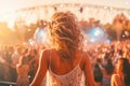 Back view of a girl dancing in front of the crowd at a music festival Royalty Free Stock Photo