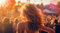 Back view of a girl dancing in front of the crowd at a music festival Royalty Free Stock Photo