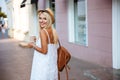 Back view of girl in dress holding take away cup Royalty Free Stock Photo