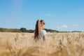 Back view of a girl in a field with spikelets. Unity with nature, the joy of being outdoors. The concept of freedom, loneliness, Royalty Free Stock Photo