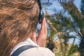 Back view on the girl in the headphones listening music  walks in the palm forest. Seychelles islands. Royalty Free Stock Photo