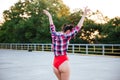 Back view of a girl in red swimsuit posing outdoors Royalty Free Stock Photo