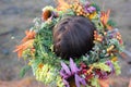 Girl`s head in a wreath of wildflowers. young woman in a flower wreath, closeup, back view. Midsummer Celebrations Kupala Night in Royalty Free Stock Photo