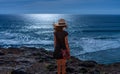 Back view of girl standing on the edge of the cliff. View of Praia do Tonel. Royalty Free Stock Photo