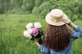 Back view beautiful girl with peonies Royalty Free Stock Photo