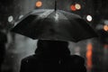 Back view of a girl walking under an umbrella in the rain on a street of a night city Royalty Free Stock Photo