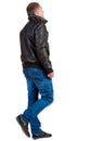 Back view of going handsome man in jacket. Royalty Free Stock Photo