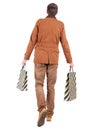Back view of going handsome man with shopping bags. Royalty Free Stock Photo